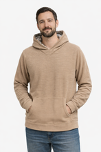 Load image into Gallery viewer, Man wearing a beige hoodie with a white background Rudy Adventures hoodie worn outdoors in Colorado

